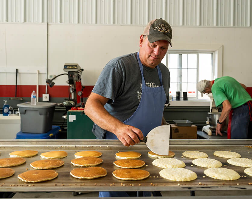Man flipping buttermilk pancakes at June Dairy Month breakfast